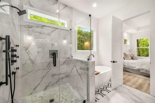 a bathroom with a bathtub and a shower