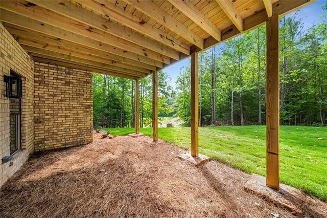 a view of a yard with porch and garden