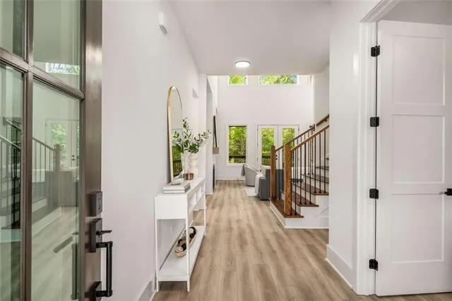 a view of a hallway with wooden floor and staircase