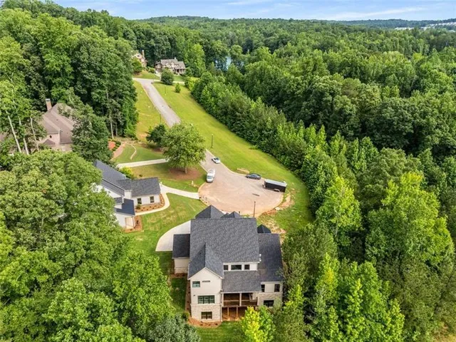 an aerial view of residential houses with outdoor space and river