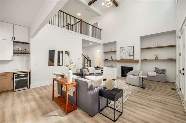 a living room with fireplace furniture and a wooden floor