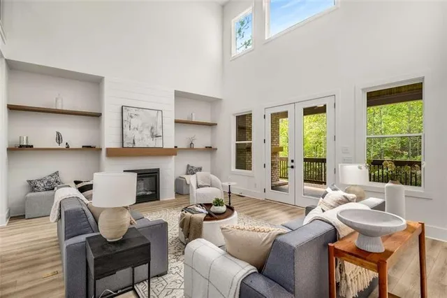 a living room with furniture fireplace and a large window