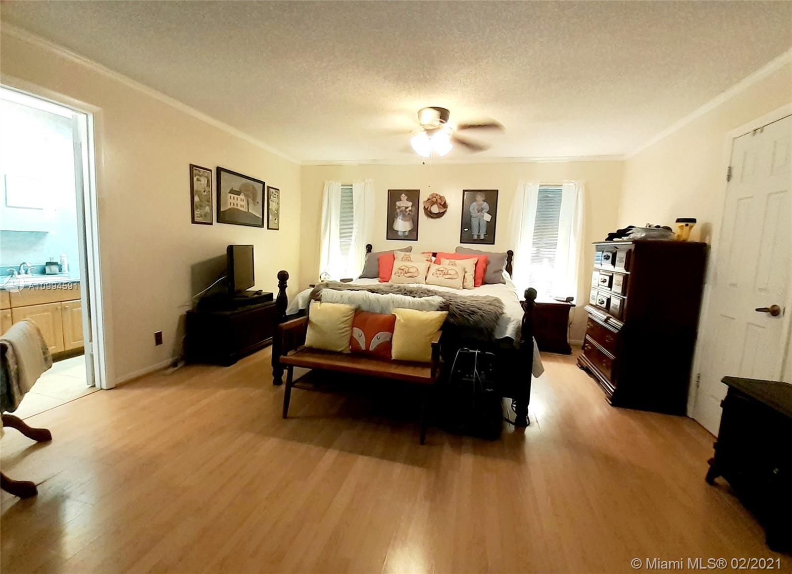 6301 Southwest 186th Way Southwest Ranches, FL 33332 - Photo 14 of 29 a bedroom with furniture and a flat screen tv