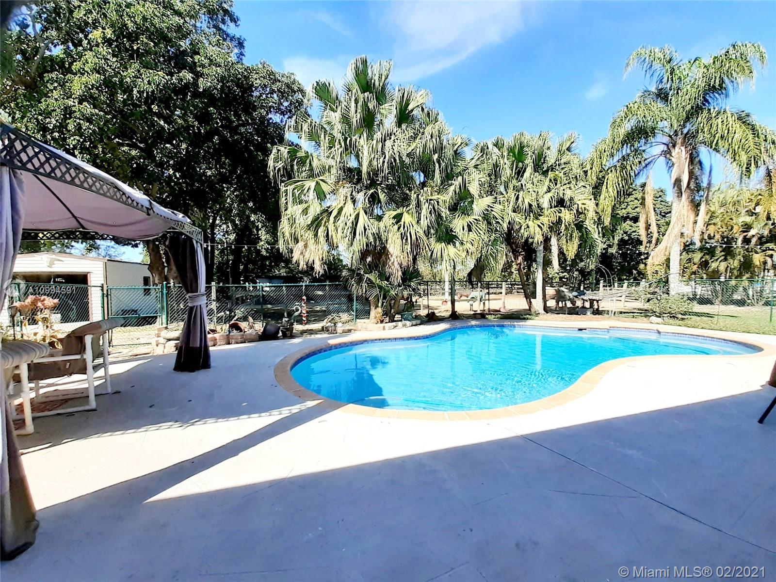 6301 Southwest 186th Way Southwest Ranches, FL 33332 - Photo 3 of 29 a swimming pool with outdoor seating and yard