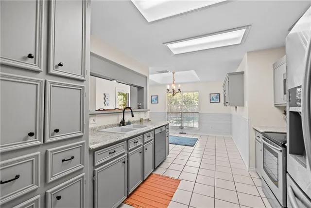 a kitchen with stainless steel appliances a sink stove and cabinets