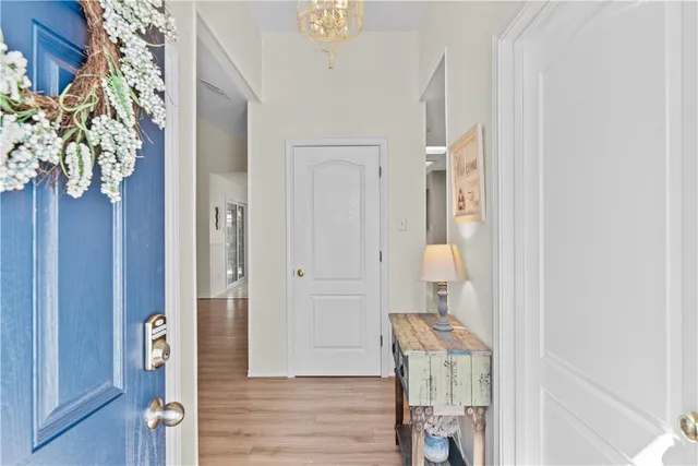 a view of hallway with wooden floor