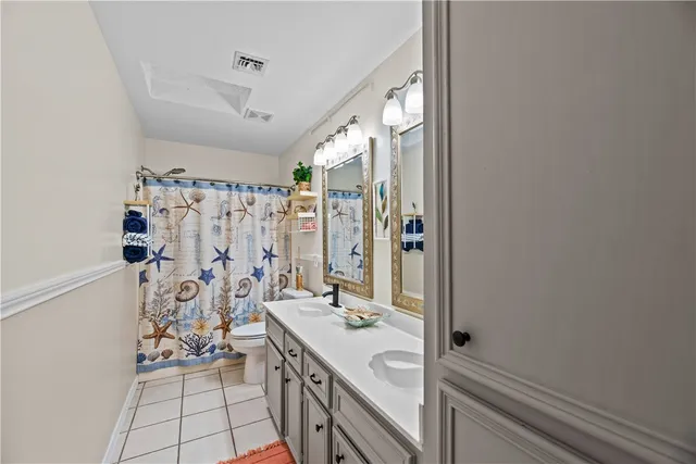 a bathroom with a granite countertop sink a mirror and a shower