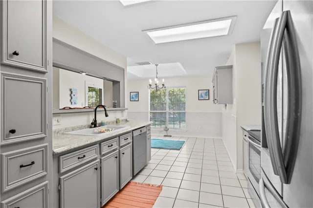 a kitchen with a sink a refrigerator and window