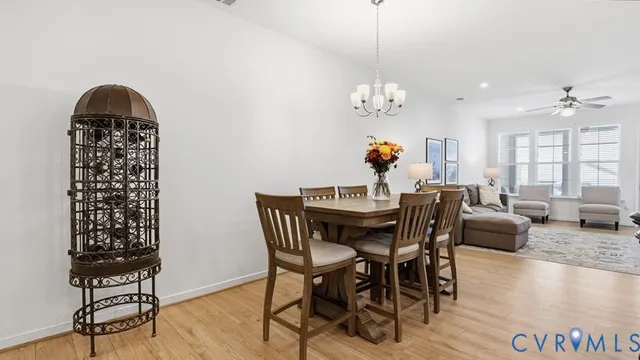 a kitchen with stainless steel appliances granite countertop a sink a stove a refrigerator and island with wooden floor