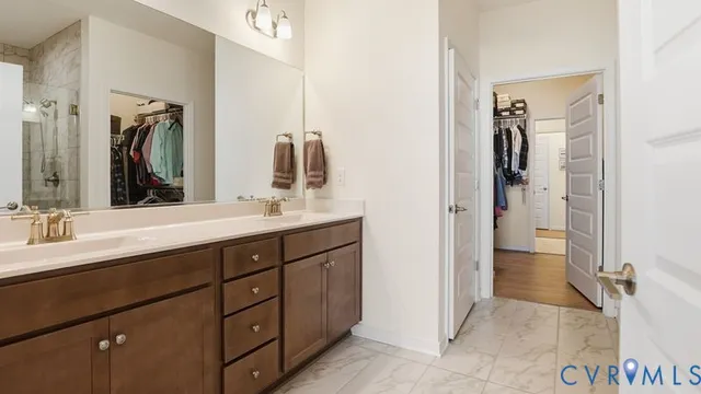 a bedroom with a bed and a flat tv screen on dresser