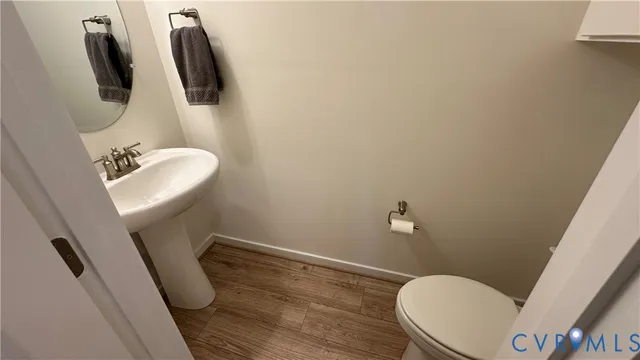 a view of the patio with dining table and chairs under an umbrella
