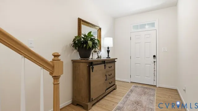 a kitchen with white cabinets and sink