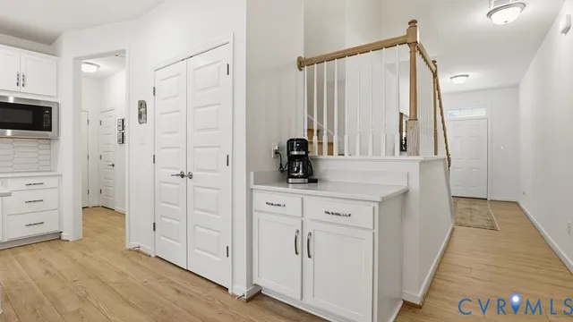 a view of kitchen with cabinets table and chairs