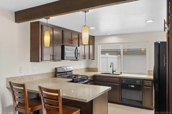 a kitchen with granite countertop a sink and cabinets