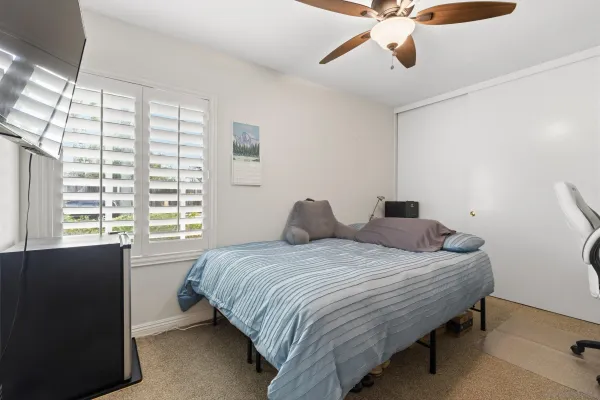 a bedroom with a bed and window