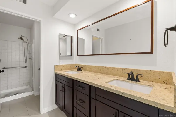 a bathroom with a granite countertop sink mirror and double