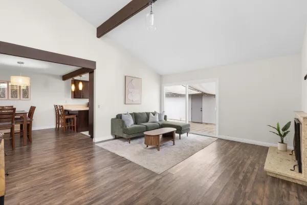 a living room with furniture and wooden floor