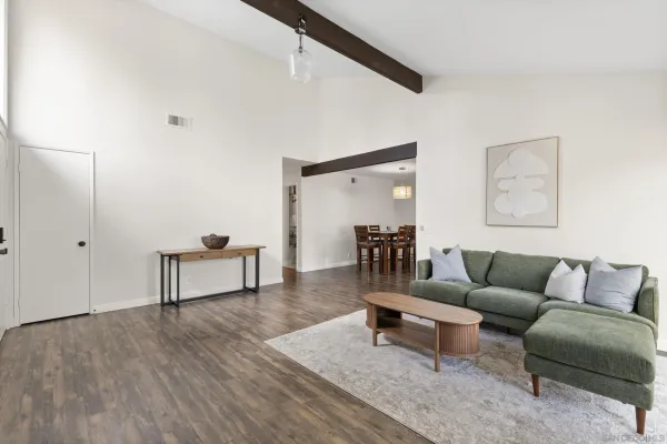 a living room with furniture and a wooden floor