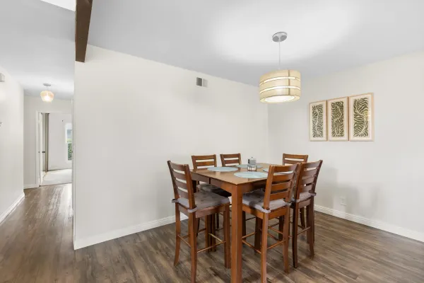 a view of a dining room with furniture and wooden floor