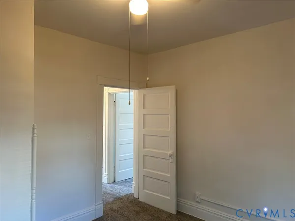 a view of walk in closet with empty racks