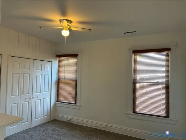 a view of a livingroom with a ceiling fan and window