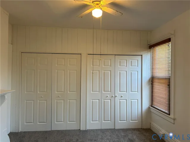 a view of a livingroom with a chandelier fan