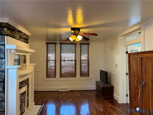 a living room with fireplace furniture and a window
