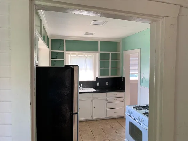 a kitchen with stainless steel appliances a refrigerator and cabinets