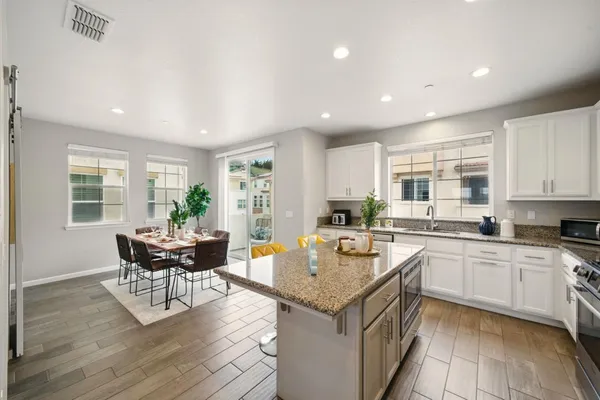 a kitchen with a stove and white cabinets