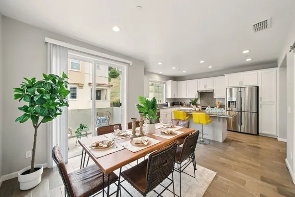 a view of a dining room with furniture and a potted plant