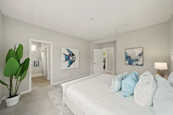 a bedroom with a bed and a painting on the wall