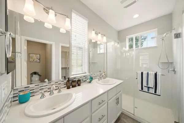 a bathroom with a double vanity sink mirror and double