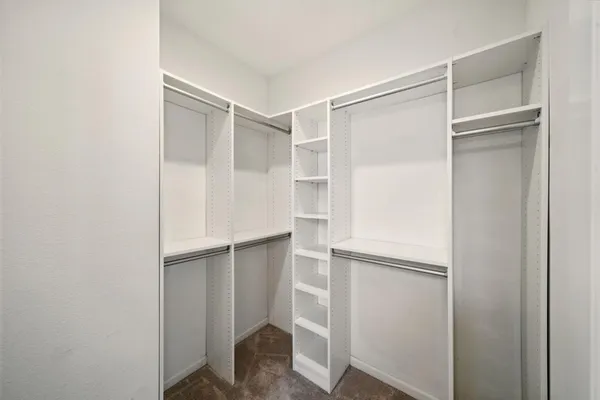 a room with an empty walk in closet