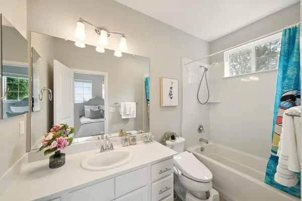a bathroom with a sink a toilet and a mirror