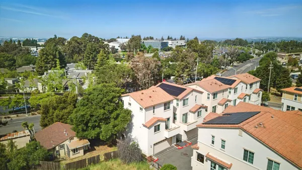 an aerial view of residential houses with outdoor space