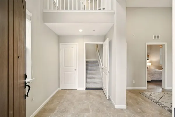 a view of a hallway with a livingroom and a bathroom