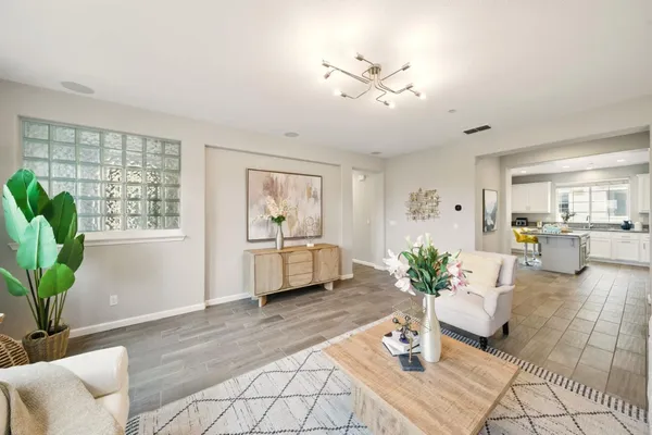 a living room with furniture potted plant and window