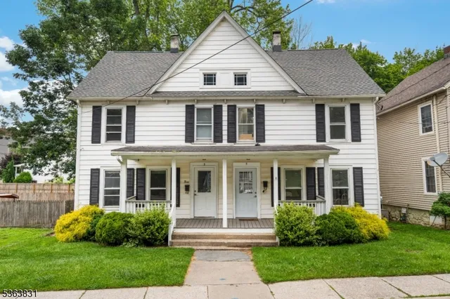 front view of a house next to a yard
