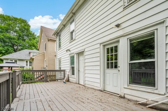 a view of a house with wooden deck