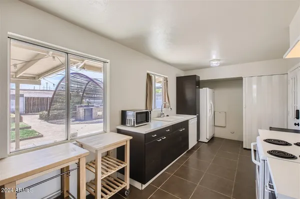 a kitchen with a stove a sink and a refrigerator