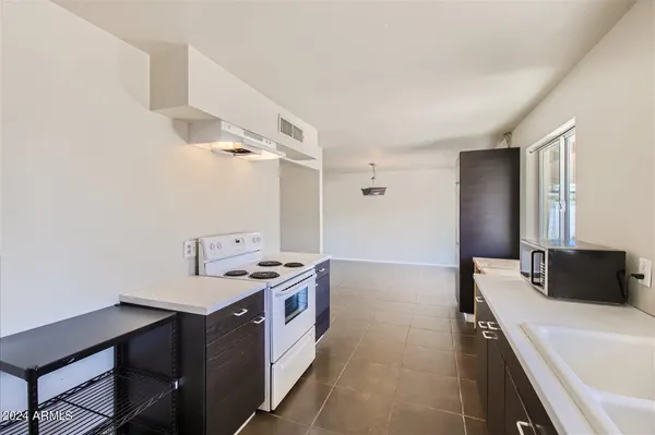 a hallway with a sink and a stove top oven