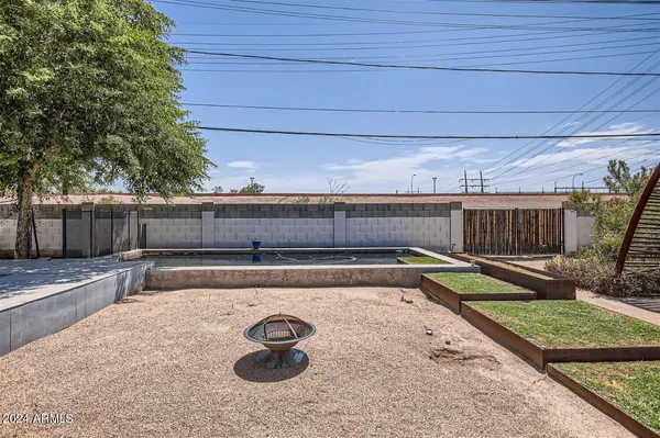 a view of a backyard with couches and wooden fence