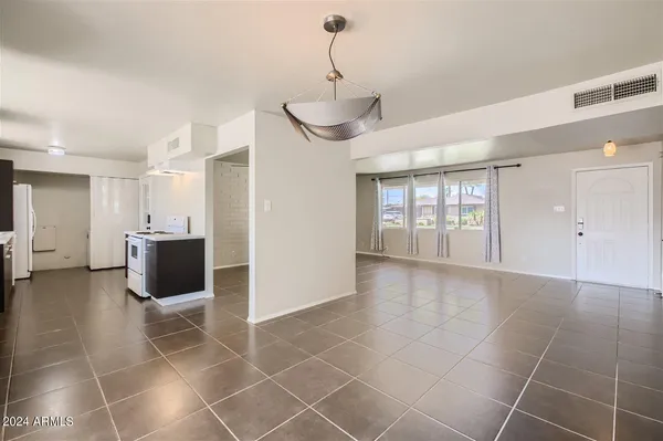 a view of a livingroom with a furniture wooden floor and windows