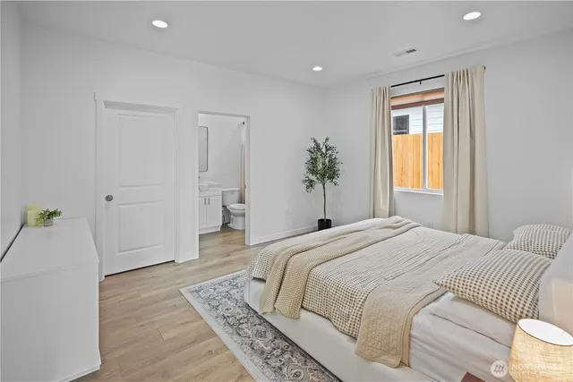 a spacious bedroom with a bed and a window