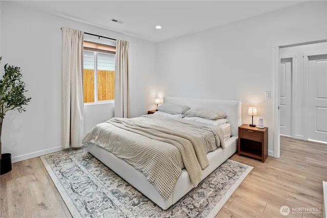 a bedroom with a large bed and a window