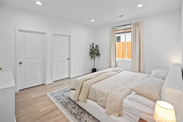 a bedroom with a large bed and a window