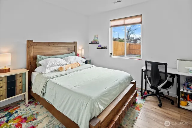 a bed sitting in a bedroom next to a window
