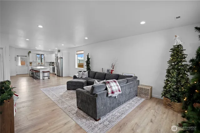 a living room with furniture and a potted plant