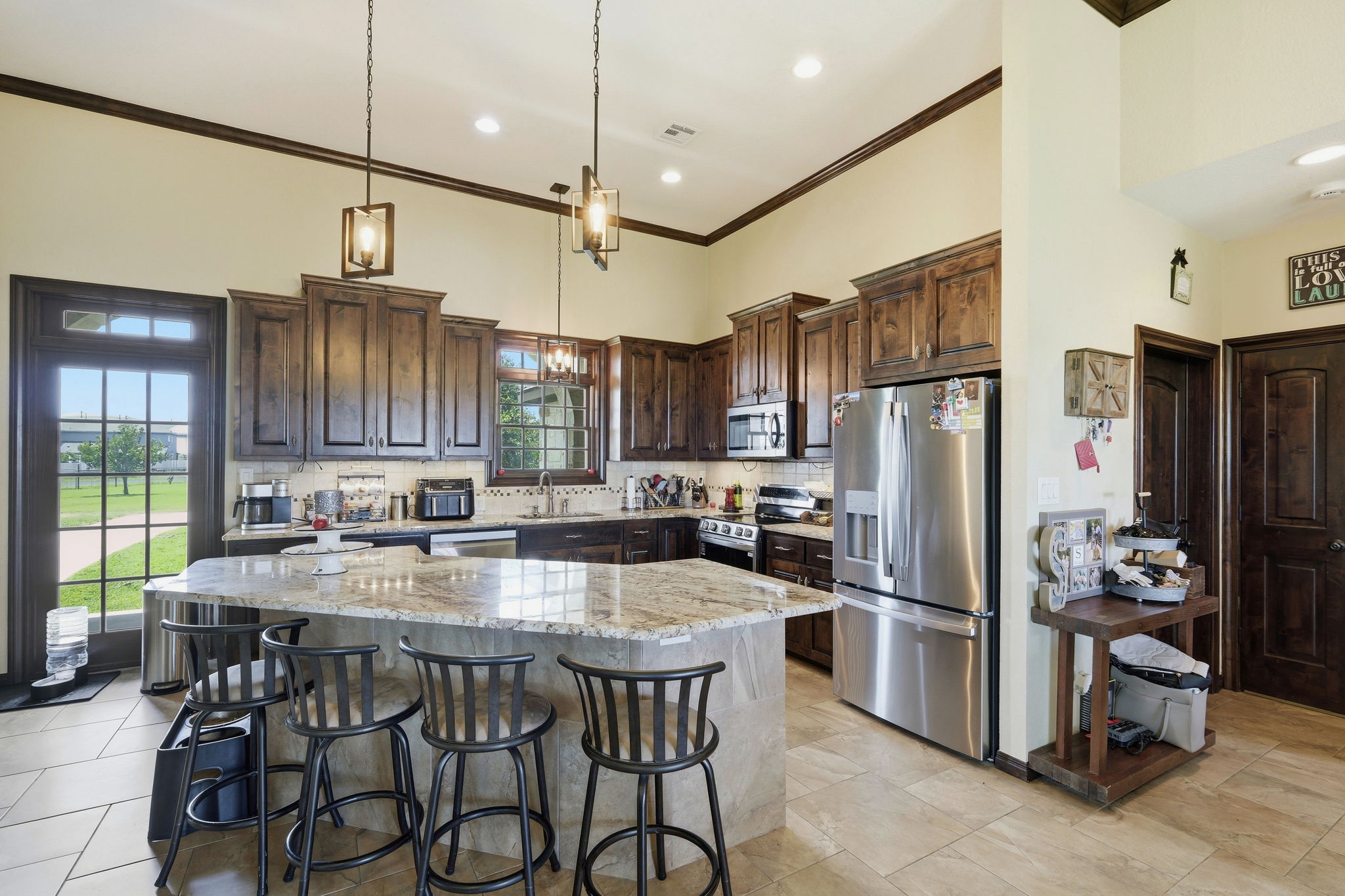 701 County Road 107 Georgetown, TX 78626 - Photo 12 of 30 a kitchen with stainless steel appliances granite countertop a refrigerator a sink a stove a dining table and chairs
