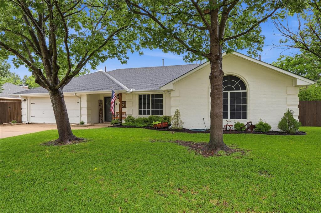 202 Colonial Heights Sanger, TX 76266 - Photo 1 of 27 a front view of a house with a garden and yard